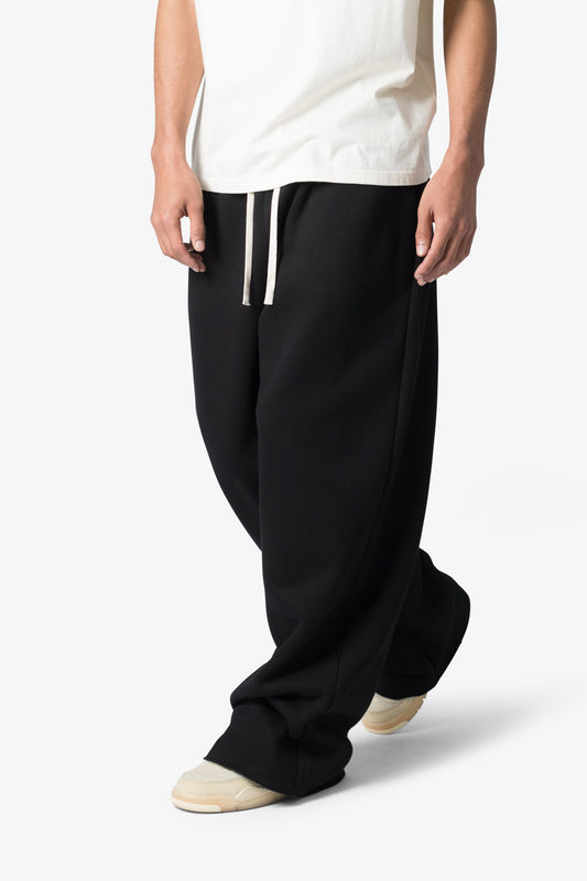 Person wearing black pants with white drawstring on a white background
