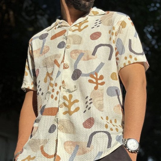 Man wearing cream retro shirt standing in urban street